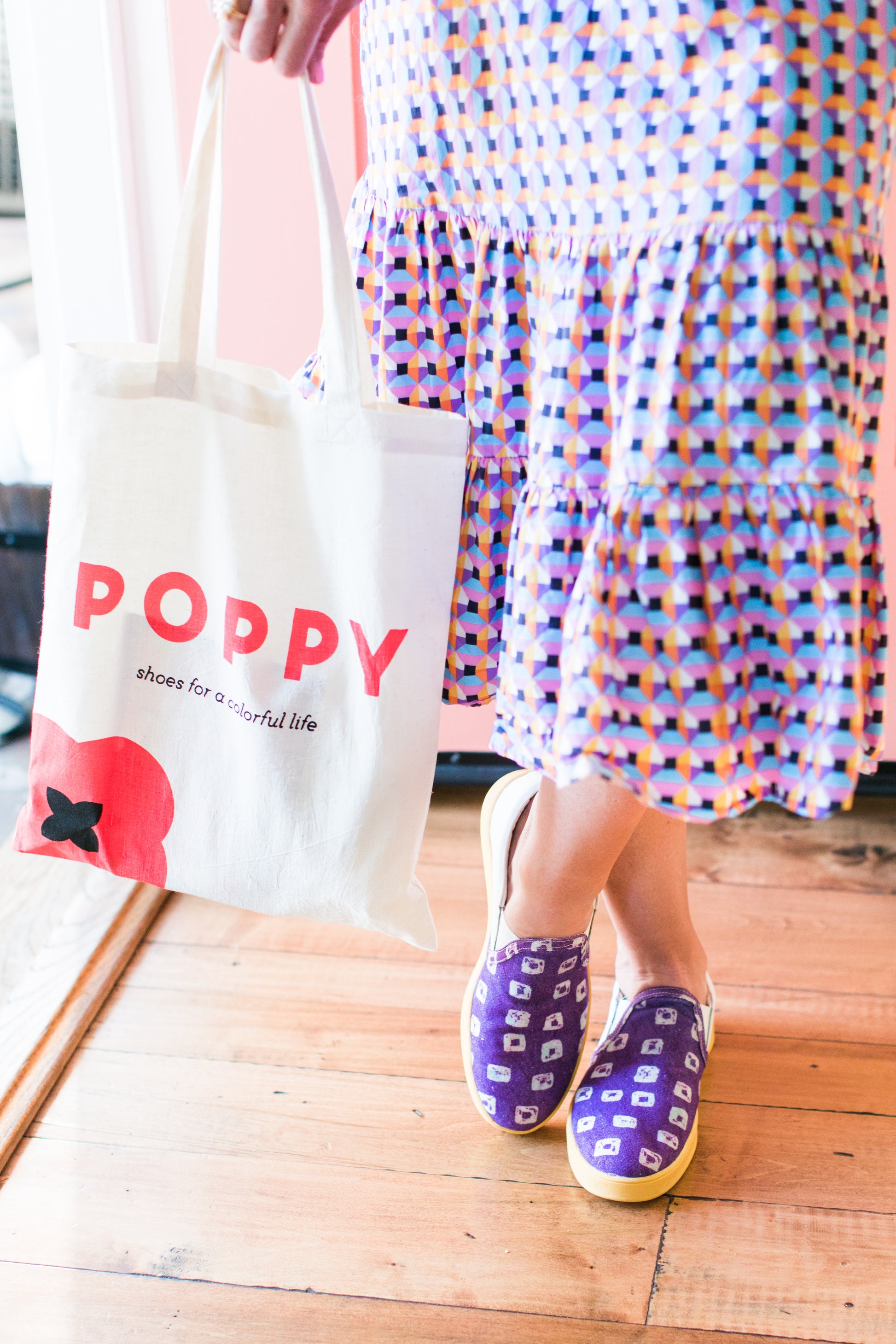 Poppy tote bag being held by female in dress