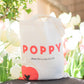 Poppy tote bag in front of flowers
