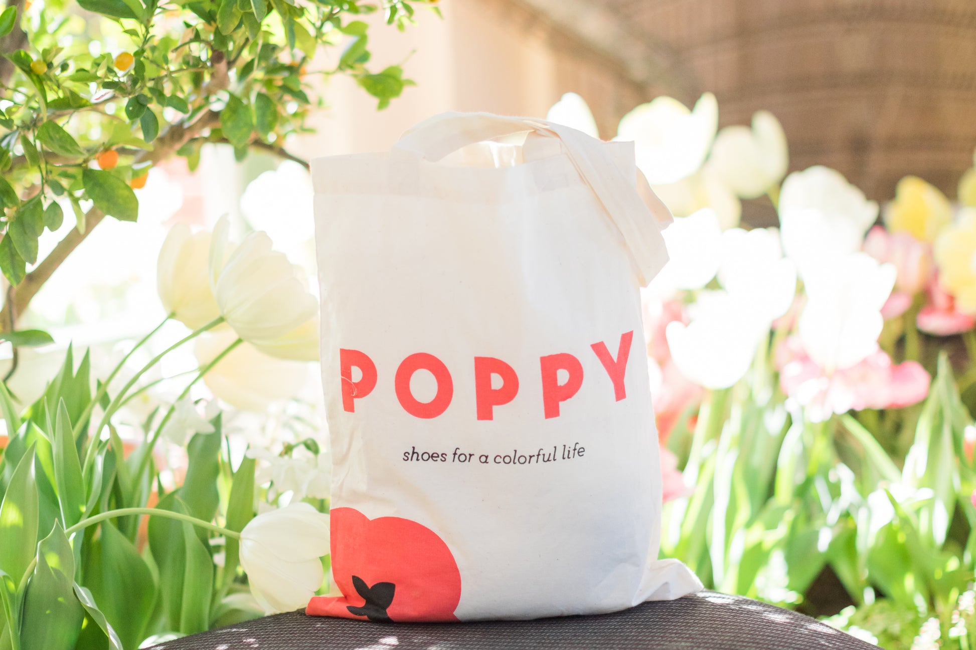 Poppy tote bag in front of flowers